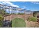 Desert landscaping and wrought iron fence offering unobstructed view of surrounding terrain at 3841 Budenny Dr, Las Vegas, NV 89122