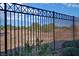 A wrought iron fence surrounds the property, desert landscaping offering unobstructed view of surrounding terrain at 3841 Budenny Dr, Las Vegas, NV 89122