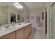 Bathroom with double sink vanity, a large mirror, and a walk-in shower at 3841 Budenny Dr, Las Vegas, NV 89122