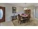 Formal dining area showcasing an oval table, stylish furnishings, and bright lighting at 3841 Budenny Dr, Las Vegas, NV 89122
