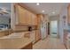Bright kitchen with tile floors, light wood cabinets, and modern appliances at 3841 Budenny Dr, Las Vegas, NV 89122