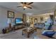 Spacious living room with a ceiling fan, carpet, and a view into the entryway at 3841 Budenny Dr, Las Vegas, NV 89122