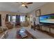 Comfortable living room with carpet, ceiling fan, and a large window for natural light at 3841 Budenny Dr, Las Vegas, NV 89122