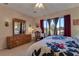 Bright main bedroom featuring a vanity, and natural light from the window at 3841 Budenny Dr, Las Vegas, NV 89122