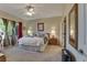 Bright main bedroom featuring a ceiling fan, large bed, and natural light from the window at 3841 Budenny Dr, Las Vegas, NV 89122