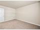 An empty, carpeted bedroom with a door and neutral walls at 5339 Indian River Dr # 281, Las Vegas, NV 89103