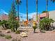 Stone sign at Bella Vita entrance with mature palms and tidy desert landscaping at 5339 Indian River Dr # 281, Las Vegas, NV 89103