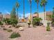 Manicured stone sign at Bella Vita entrance with palm trees and rock landscaping at 5339 Indian River Dr # 281, Las Vegas, NV 89103