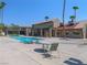 Inviting community pool with lounge seating, a pergola, and a nearby building at 5339 Indian River Dr # 281, Las Vegas, NV 89103