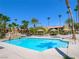 Beautiful community pool with rock features, palm trees, and plenty of seating at 5339 Indian River Dr # 281, Las Vegas, NV 89103