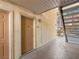 Apartment entrance with a neutral color scheme, covered walkway, and view of outdoor stairwell at 5339 Indian River Dr # 281, Las Vegas, NV 89103