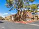 Exterior shot of well-maintained condos with red trim, mature trees, and a charming neighborhood feel at 5339 Indian River Dr # 281, Las Vegas, NV 89103