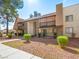 Exterior view showing balconies and stone accents surrounded by manicured landscaping at 5339 Indian River Dr # 281, Las Vegas, NV 89103
