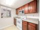 Bright kitchen featuring wood cabinets, stone countertops, and modern white appliances at 5339 Indian River Dr # 281, Las Vegas, NV 89103