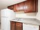 Charming kitchen featuring wood cabinets, granite counters, and modern appliances at 5339 Indian River Dr # 281, Las Vegas, NV 89103