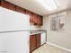 Charming kitchen featuring wood cabinets, granite counters, and modern appliances at 5339 Indian River Dr # 281, Las Vegas, NV 89103