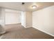 Neutral living area shows plush carpet, neutral walls, and doorway to the kitchen at 5339 Indian River Dr # 281, Las Vegas, NV 89103
