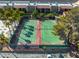 Birds eye view of fenced tennis courts with mature trees offering shade at 5339 Indian River Dr # 281, Las Vegas, NV 89103
