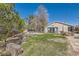 Well-maintained backyard with a gazebo, lush lawn, and rock features, ideal for outdoor enjoyment and relaxation at 537 Tuscany View St, Las Vegas, NV 89145