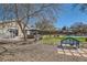 Lush backyard with a gazebo, pool, and inviting bench seating, perfect for relaxing and enjoying the outdoors at 537 Tuscany View St, Las Vegas, NV 89145