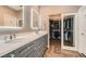 Bathroom vanity with double sink, crystal knobs, a lighted mirror and walk-in closet at 537 Tuscany View St, Las Vegas, NV 89145