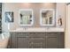Contemporary bathroom vanity featuring a double sink with lighted mirrors, and quartz countertop at 537 Tuscany View St, Las Vegas, NV 89145
