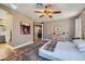 Cozy bedroom with decorative ceiling fan, area rug, and doorway to a modern bathroom and closet at 537 Tuscany View St, Las Vegas, NV 89145