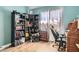 Secondary bedroom with a window, a wooden floor, bookshelves and desk at 537 Tuscany View St, Las Vegas, NV 89145