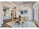 Open dining room with chandelier, wood floors, and views to the front yard at 537 Tuscany View St, Las Vegas, NV 89145