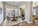 Elegant dining room with wood floors, large window, and stylish light fixture at 537 Tuscany View St, Las Vegas, NV 89145