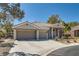 Charming single-Gathering home with a tile roof, three car garage, desert landscaping and a well-manicured lawn at 537 Tuscany View St, Las Vegas, NV 89145