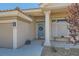 Inviting front porch with stone accents, desert landscaping, a wood bench and a decorative wreath at 537 Tuscany View St, Las Vegas, NV 89145