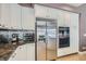 Kitchen with stainless steel refrigerator and double ovens surrounded by white cabinets at 537 Tuscany View St, Las Vegas, NV 89145