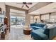 Open concept living room with kitchen, large sectional, and sliding glass doors to the backyard at 537 Tuscany View St, Las Vegas, NV 89145