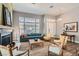 Cozy living room with a fireplace, hardwood floors, modern furniture, and natural light at 537 Tuscany View St, Las Vegas, NV 89145