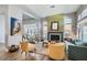 Open-concept living room with a fireplace, hardwood floors, modern furniture, and natural light at 537 Tuscany View St, Las Vegas, NV 89145