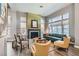 Inviting living room featuring a cozy fireplace, large windows, and comfortable seating at 537 Tuscany View St, Las Vegas, NV 89145