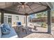 Stylish covered patio with plush seating, a decorative ceiling fan, and elegant furniture, perfect for outdoor living at 537 Tuscany View St, Las Vegas, NV 89145