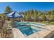 Inviting pool and spa surrounded by lush greenery, offering a private and refreshing outdoor oasis at 537 Tuscany View St, Las Vegas, NV 89145