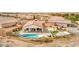 Aerial view of the home showcasing the backyard pool, covered patio, desert landscaping, and neighborhood at 5755 E La Campana Dr, Pahrump, NV 89061