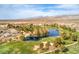 Aerial view of the golf course and surrounding community highlighting the beautiful desert landscape and blue lake at 5755 E La Campana Dr, Pahrump, NV 89061