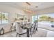 Dining room with a contemporary chandelier, sliding glass doors, and views of the beautiful outdoor pool at 5755 E La Campana Dr, Pahrump, NV 89061
