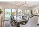 The dining area is showcased with a dining table, decorative rug, lighting fixture, and pool views from windows at 5755 E La Campana Dr, Pahrump, NV 89061