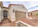 Beautiful home exterior showing the front door, brick driveway, and two-car garage with a tile roof at 5755 E La Campana Dr, Pahrump, NV 89061