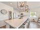 Kitchen island with stainless steel appliances and modern lighting at 5755 E La Campana Dr, Pahrump, NV 89061