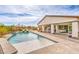 Beautiful pool with a tanning ledge, rock waterfall feature, and covered patio for backyard entertaining at 5755 E La Campana Dr, Pahrump, NV 89061