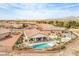 Aerial view of a beautiful home with a pool, landscaping, and a spacious backyard at 5755 E La Campana Dr, Pahrump, NV 89061
