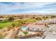 Home with a backyard oasis featuring a sparkling pool, patio, and manicured lawn, offering stunning views at 5755 E La Campana Dr, Pahrump, NV 89061