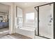 Bathroom featuring a soaking tub, separate shower, and views into the main bedroom at 5755 E La Campana Dr, Pahrump, NV 89061