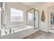 Bright bathroom boasts a soaking tub, a glass shower, and stylish finishes and fixtures at 5755 E La Campana Dr, Pahrump, NV 89061